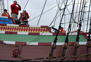 Firing a swivel gun salute, as seen from the water.