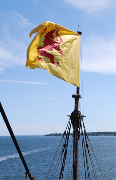 The Lion Rampant flag flaps atop the fore mast.