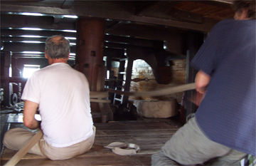 Mr. Greenberg and Mr. Padalka tend the anchor rode as it winds around the lower capstan.