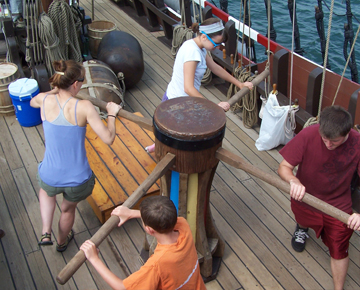 Ms. Johnsen, Ms. Robinson, Mr. Ellis, and Mr. Reynolds walk the capstan.