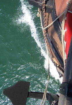 The Half Moon's bow cuts through the foamy brine.