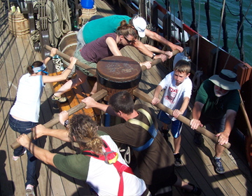 The crew walks the capstan.