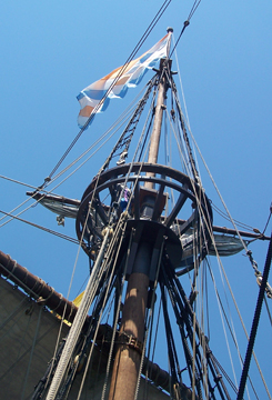 The top yard rises, setting the topsail.