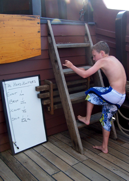 Mr. Reynolds climbs past a whiteboard listing running tallies of obscure head cleaning tasks.