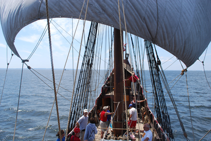 The main course arcs out as it fills with wind.