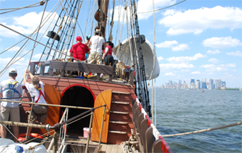 An animated sequence of the bow of the ship rolling across the waves toward NYC.