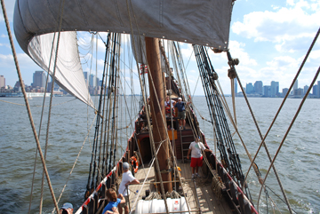 The ship heels sharply, with NYC to one side and Jersey City to the other.