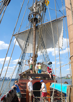 The fore mast crew sets the fore course.