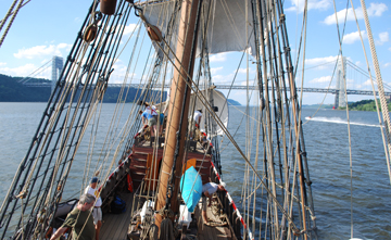 The ship heels sharply to starboard as it approaches the George Washington Bridge.