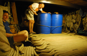 Kipp and Rachel look amused as they wait by the anchor rode on the orlop deck.