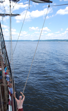 Nora swings into the water in a wide shot.