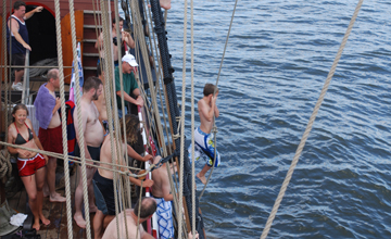 Nick swings into the water.