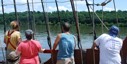The crew gazes through the shrouds at Vanderbilt Manor.