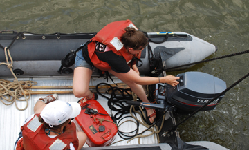 Rachel and Sanne start the Zodiac's outboard.