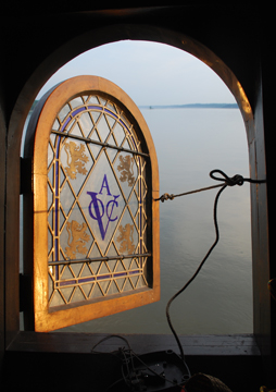 The setting sun's golden light reflects off the open transom window.