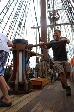 The crew walks the capstan.