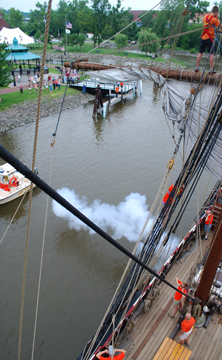 The Half Moon fires a falconet salute as it approaches the Hudson dock.