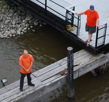 Woody Woodworth and Grant Prime wait on shore to handle the ship's docklines.