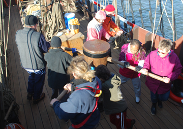 The crew walks the capstan.