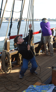 Brandon hauls on a topsail clew.