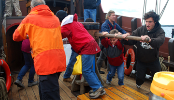 The crew walks the capstan under a heavy load.