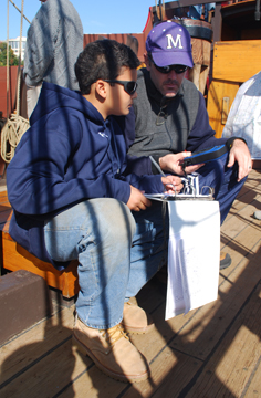 Matt consults with Mr. Hourigan over the Deck Log.