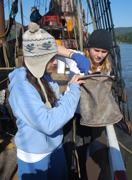 Taylor and Sophia collect a water sample.