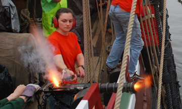 Ms. Laufer fires a swivel salute at the Marist docks.