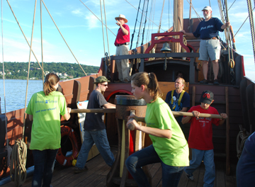 Students walk the capstan to weigh the anchor.