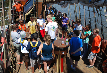 The students gather around Mr. Boudreau on the weather deck.