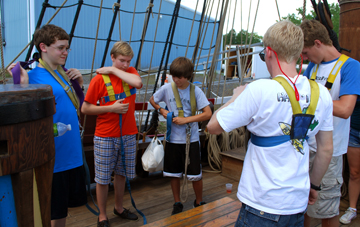 Mr. Boudreau and Mr. Boyle lead Jack, Alex, and Matt G. through harness training.