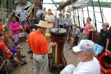 Captain Reynolds briefs the gathered crew on deck.