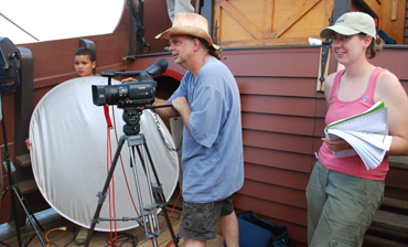 Matt B., Mr. Woodworth, and Ms. Niehaus set up a shot on deck.