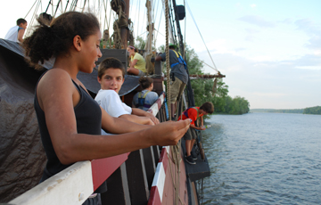 Alanna and Vincent look out over the rail while others are busy in the background.