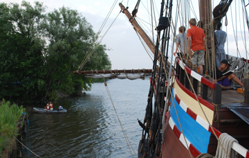 Students watch as Mr. Boudreau and Mr. Boyle row the Zodiak to shore.