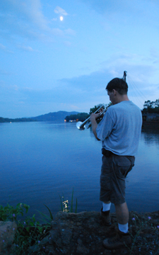 Mr. Weisse plays trumpet over the river.