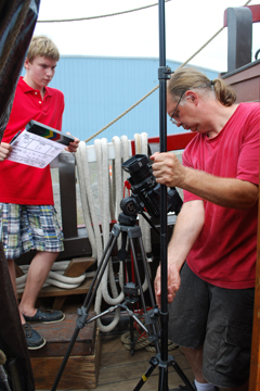 Alex stands ready with the clapboard while Mr. Woodworth sets up a shot.