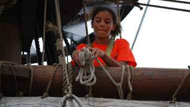 Alanna coils a gasket at the main course yard.