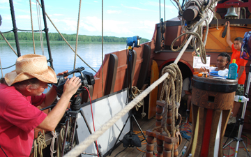 Mr. Woodworth, Raynika, and Matt B. prepare to film a scene of Matt ringing the ship's bell.