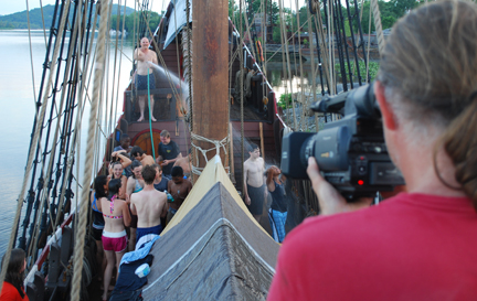 The crew cools off during a deck wash.