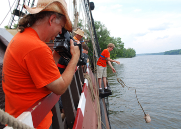 Mr. Woodworth tapes Alex tossing a water sample bucket into the river.
