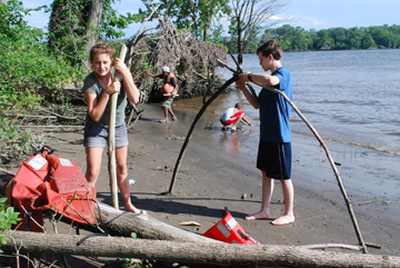Abby and Jack build a hut while Jason and Tahari gather supplies on the beach.