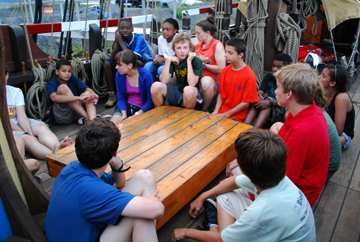 The students gather 'round the main hatch to have fun.
