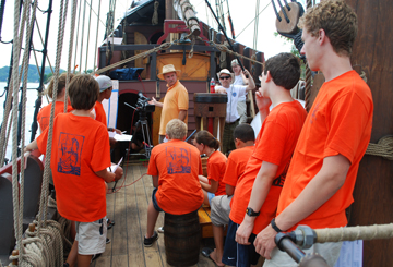 Captain Reynolds directs the crew on the weather deck.