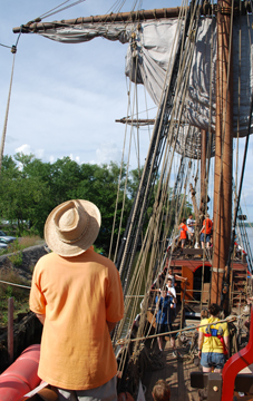 Captain Reynolds watches students set the main course.