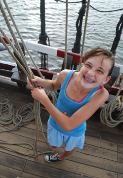 Nora handles the clew, martnet, and bunt lines with a smile.