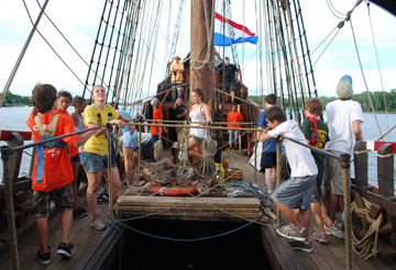 The crew hustles and bustles on the weather deck.