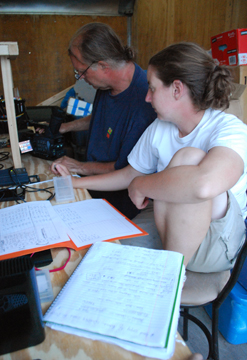 Mr. Woodworth and Ms. Niehaus review footage in the trailer.