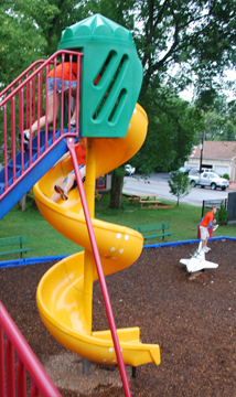 Abby chases Nick down a spiral slide.