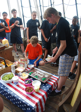 Nick and Alex serve themselves cake and ice cream.